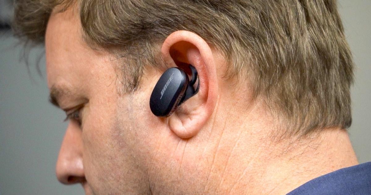 man wearing bose quietcomfort earbuds