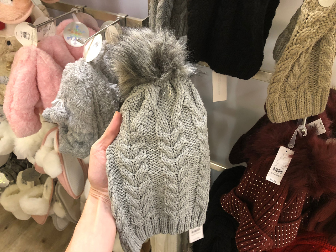 hand holding Pom-Pom Beanies
