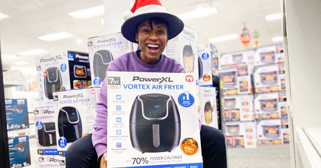 woman holding powerxl air fryer box