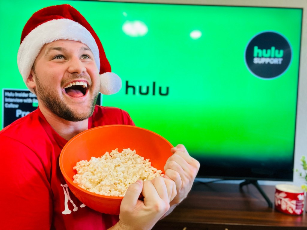 man eating popcorn and watching HULU