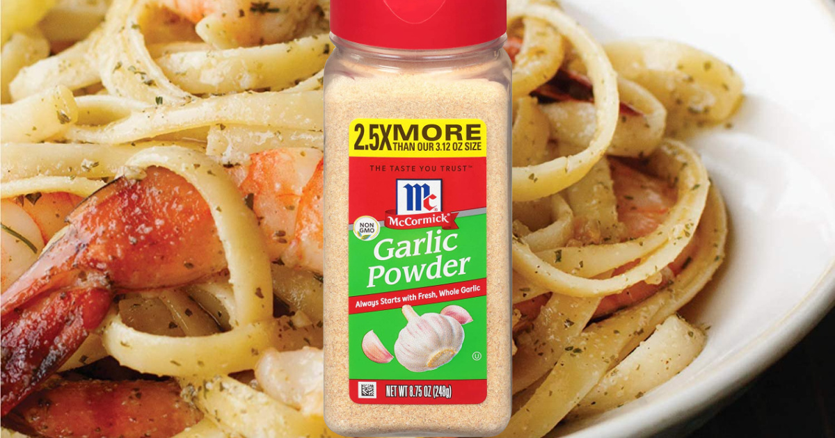 bottle of garlic powder sitting in front of plate that has shrimp and noodles on it