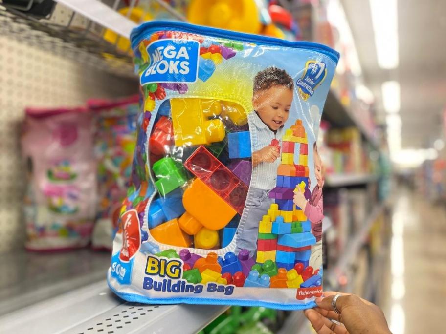 hand holding blue mega blocks building set in store