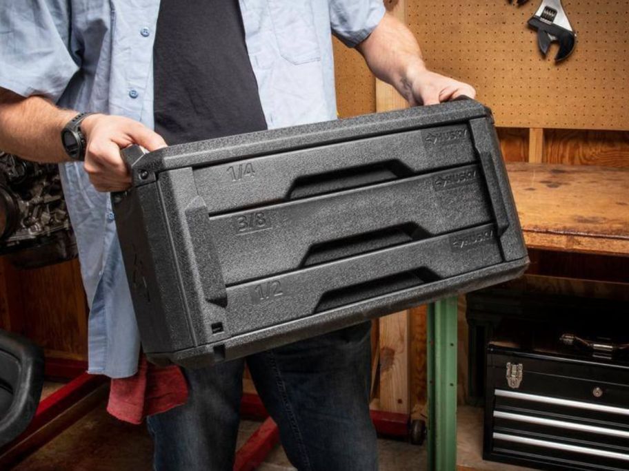 Man carrying a Husky Mechanics Tool Set