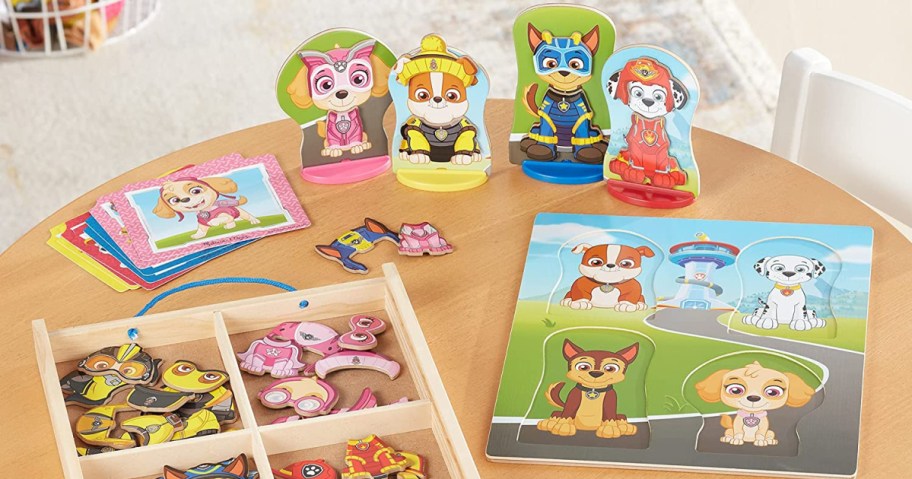 Melissa & Doug Paw Patrol Wooden Magnetic Pretend Play 64-Count Set on table