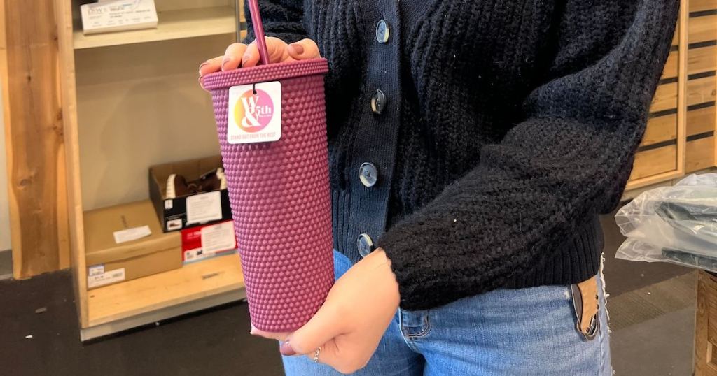 woman holding burgundy studded starbucks travel tumbler with straw