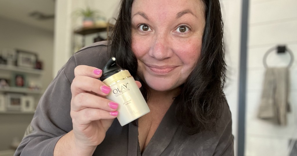 woman holding face cream