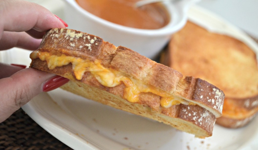 hand holding up an air fryer grilled cheese sandwich
