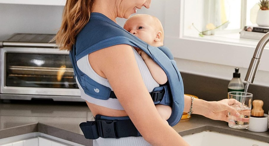 woman-wearing-baby-carrier-while-getting-water