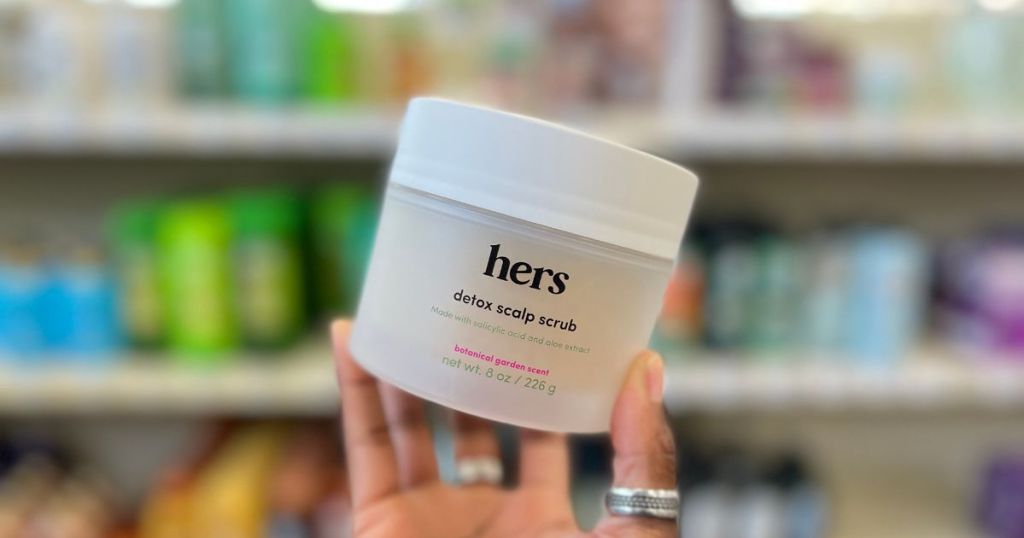 hand holding jar of hers detox scalp scrub