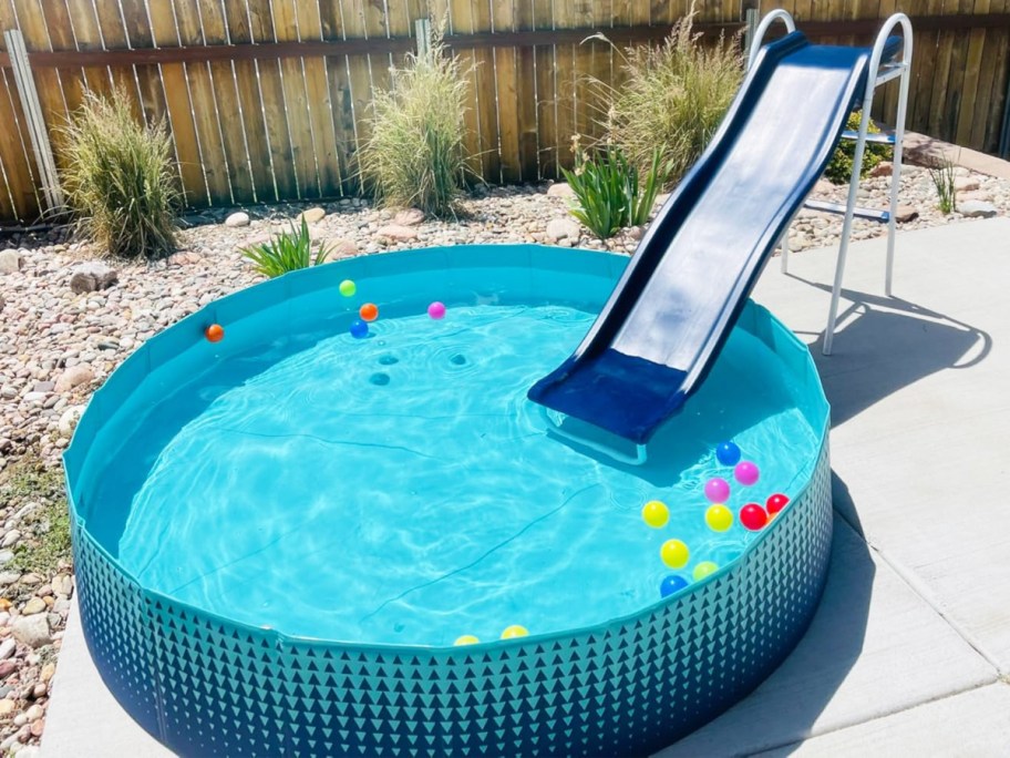 blue slide leading into a kids blue pool