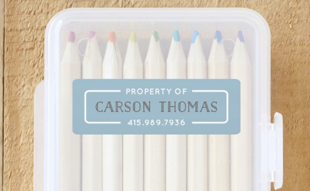 clear pencil case with colored pencils and minted name labels