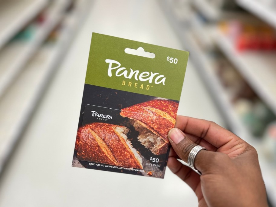 holding a panera gift card