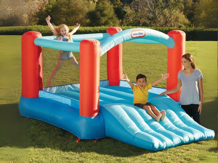 kids playing on little tikes bounce house outside
