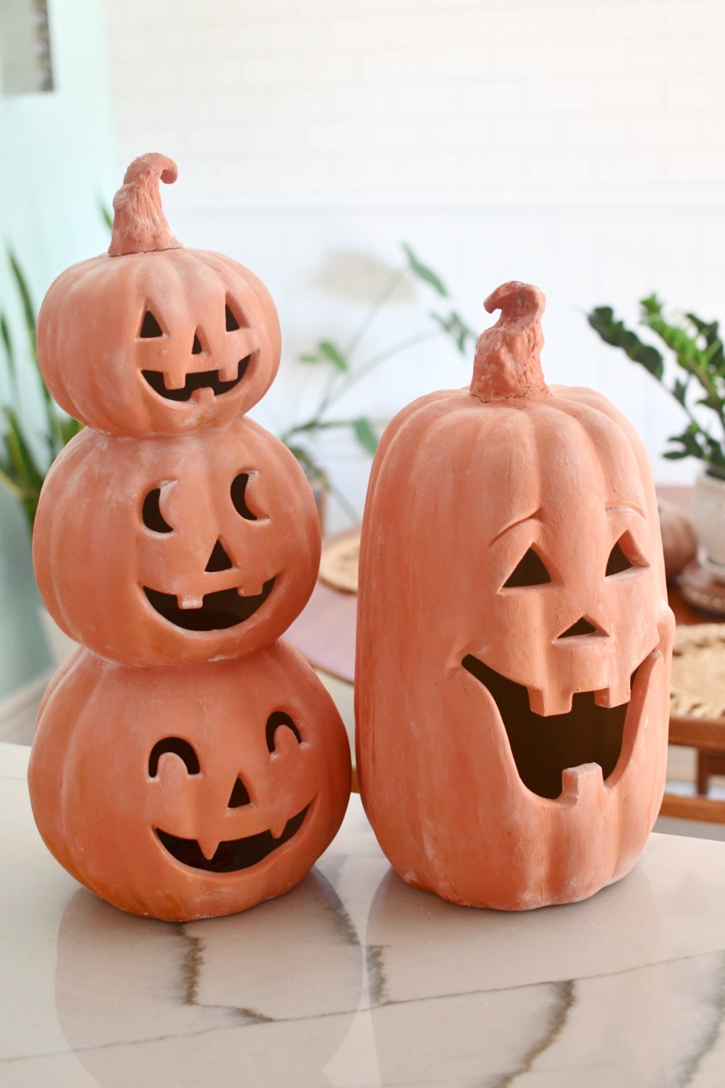 pair of painted terracotta pumpkins on the counter