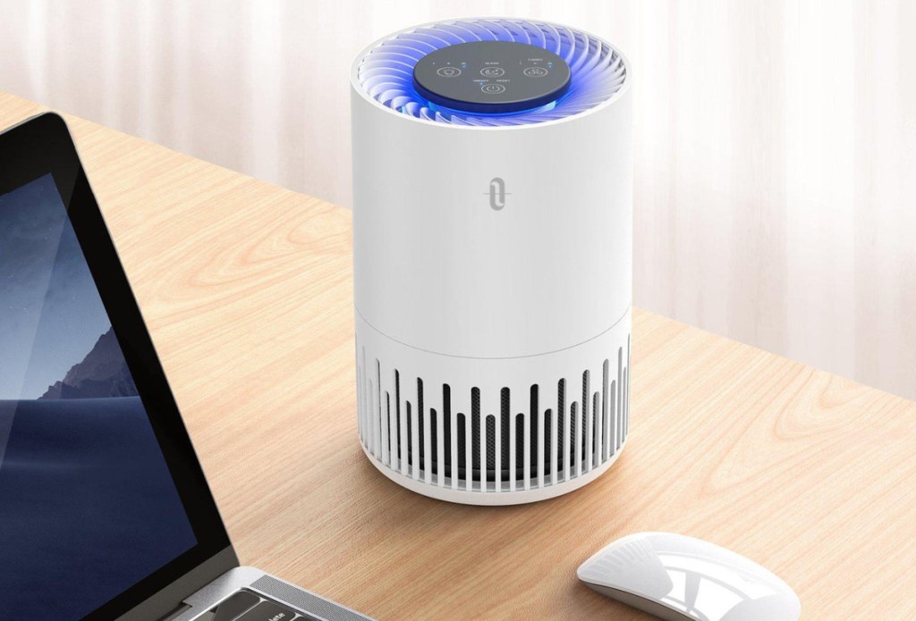 Taotronics HEPA Desktop Air Purifier on a desk next top a laptop and working mouse