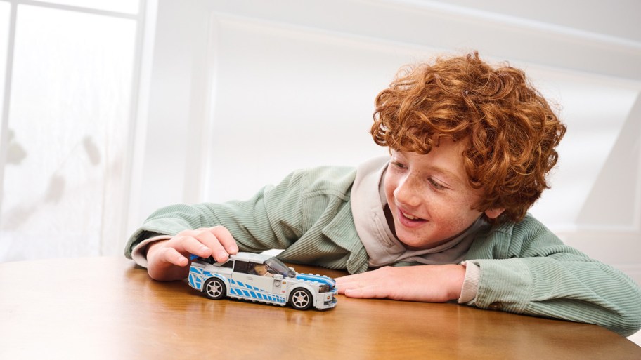 Boy playing with the 2 fast 2 furious Lego set from Walmart