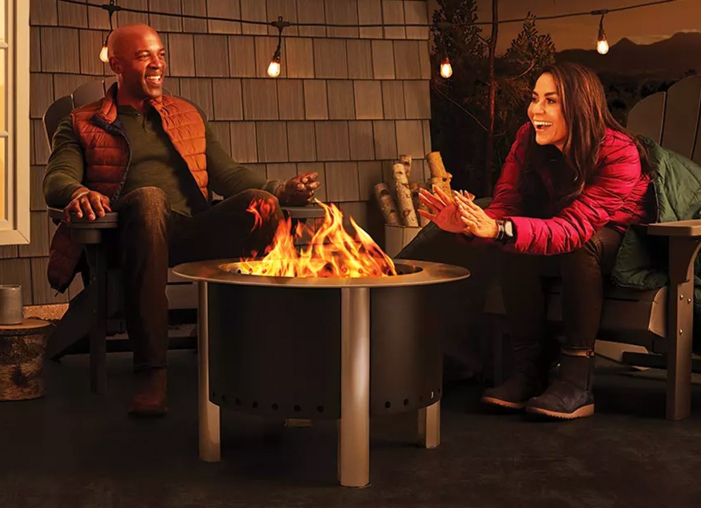 people sitting around fire pit