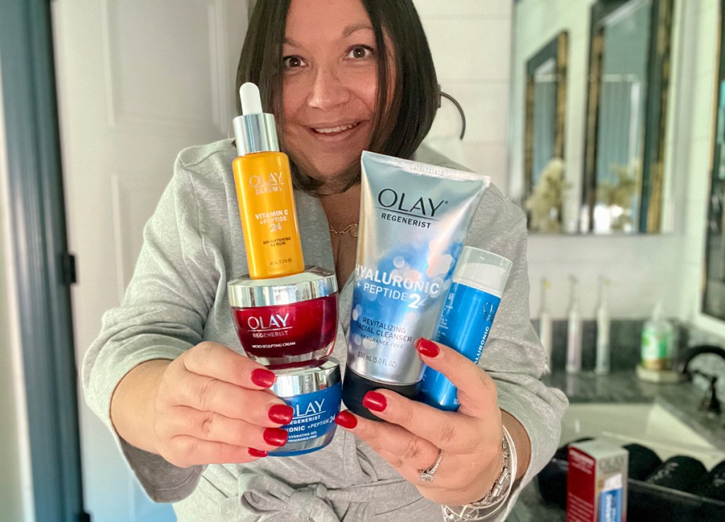 woman holding olay skincare products