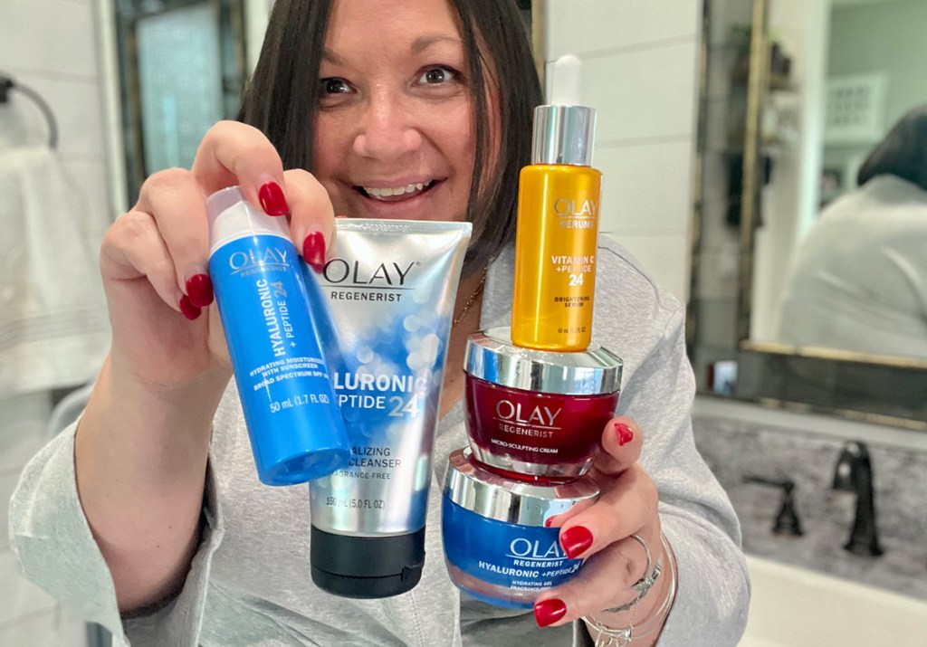 woman holding olay skincare products