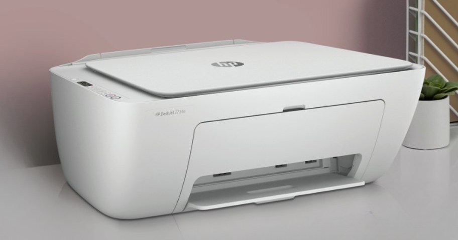 white HP printer on a desk