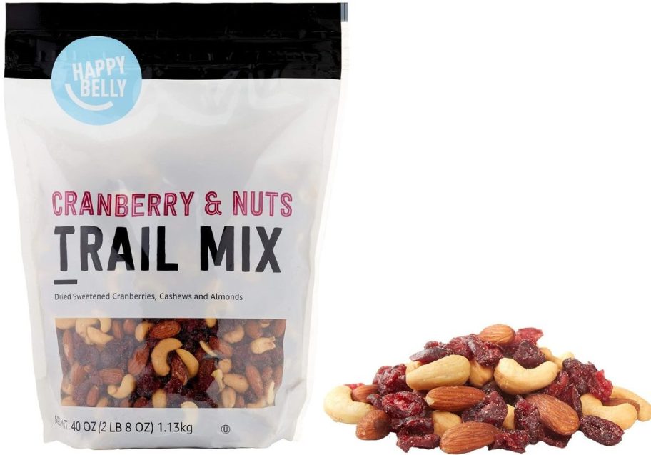 Happy Belly Cranberry & Nuts Trail Mix 40oz Bag next to a pile of mixed nuts