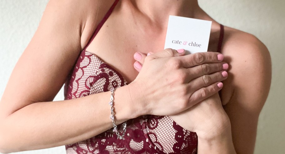 woman wearing cate & chloe bracelet while holding the box it comes in