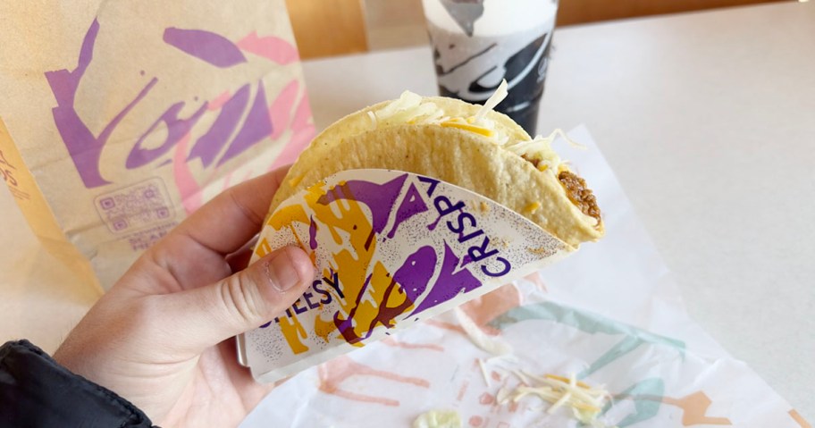 hand holding crispy taco at taco bell