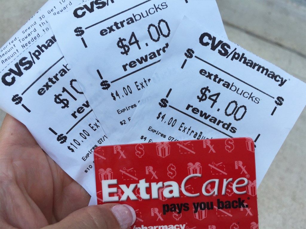 hand holding cvs card and extrabucks