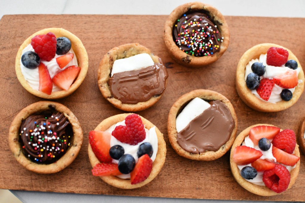A tray with various stuffed cookie cups on the counter. 