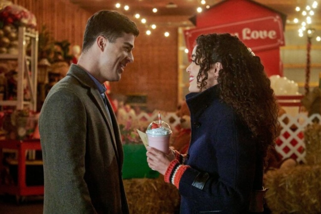 man speaking with woman who's holding a frozen pink drink