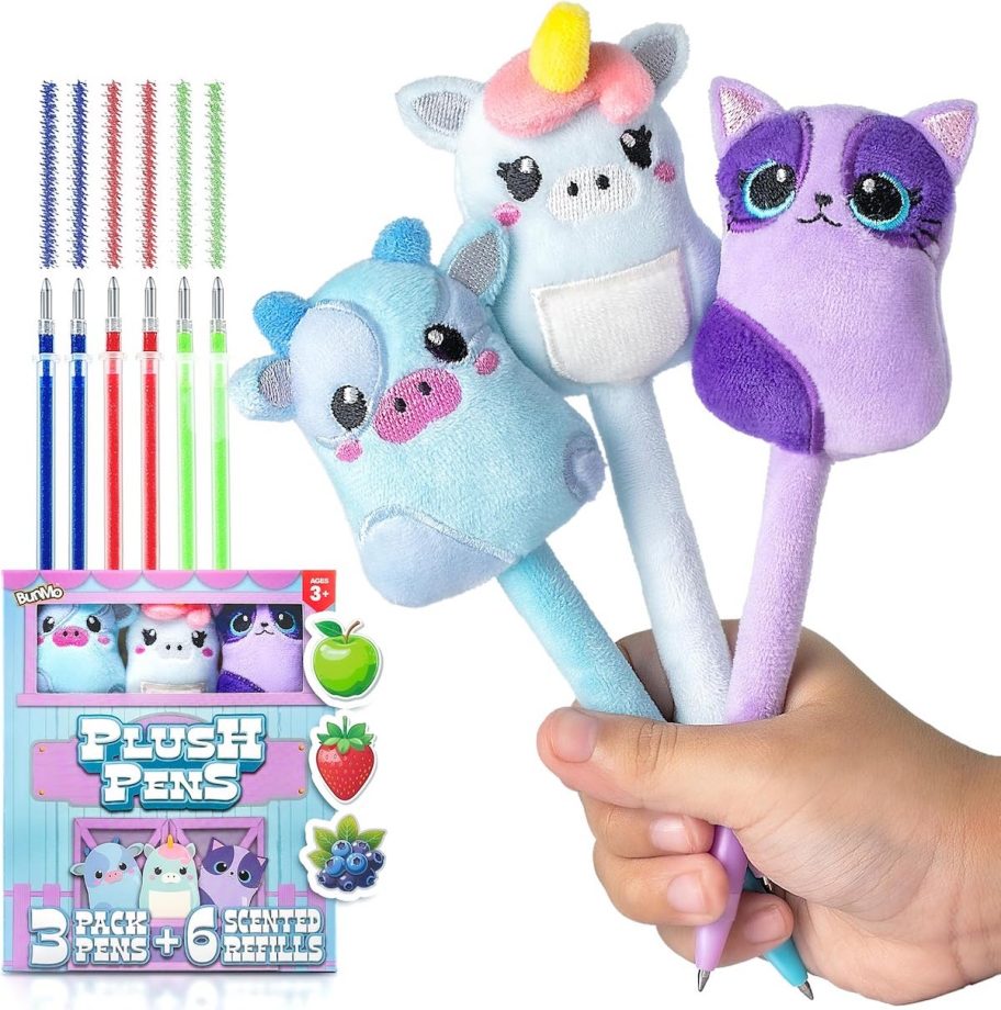 kids hand holding plush pens