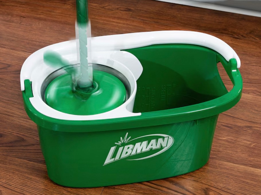 green and white spin mop on bucket 