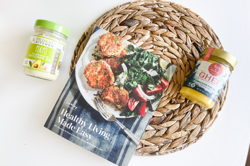 cookbook, ghee, and mayo on rattan circle
