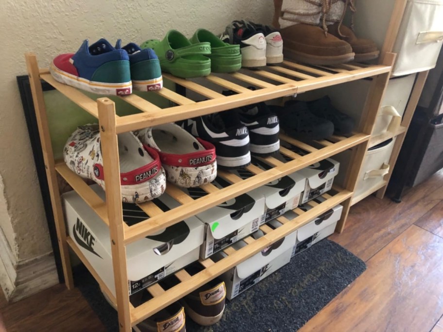 a bamboo shoe rack with shoes on it