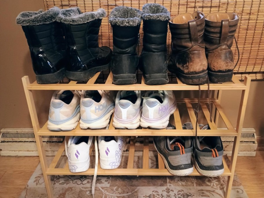 a bamboo shoe rack with shoes on it