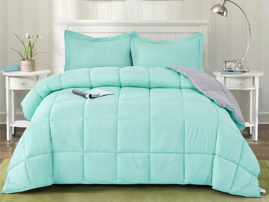 teal comforter set on bed in bedroom