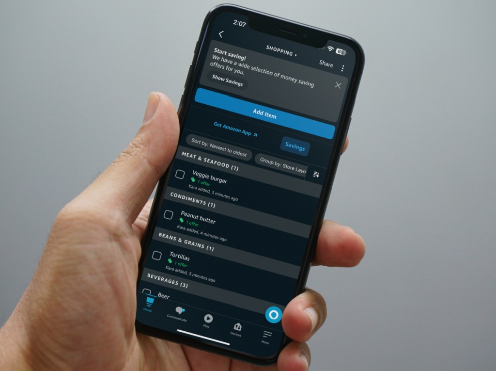 Man showing offers from the Alexa shopping list displayed on his phone