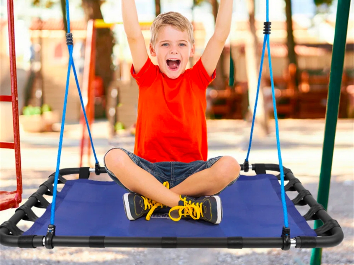 boy sitting on platform tree swing