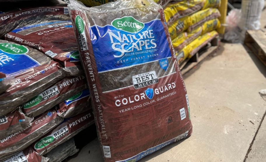 Bag of mulch leaning against other bags