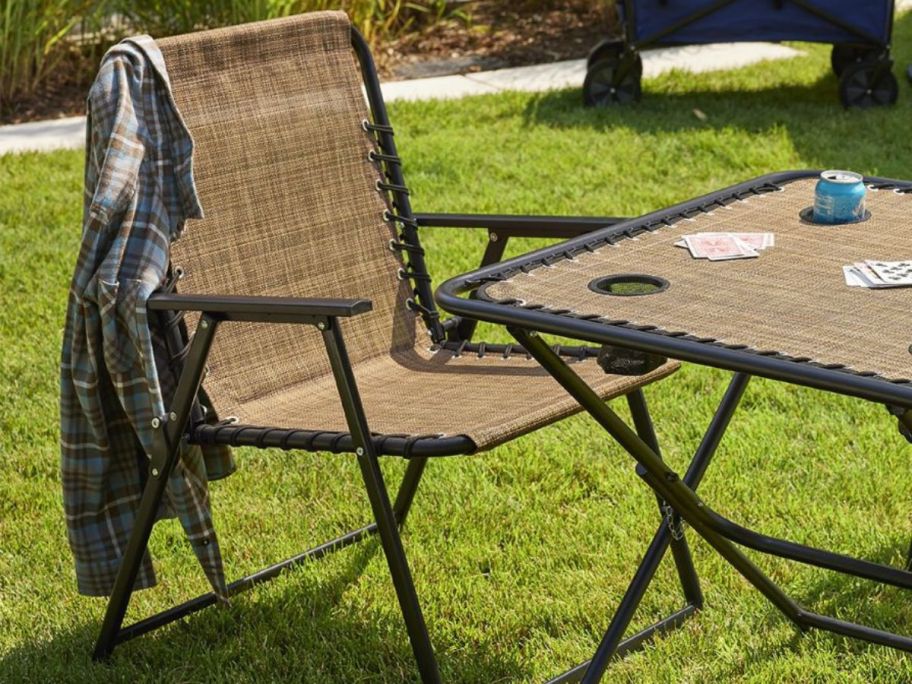 a brown sonoma goods antigravity folding chair and table in brown outside on a lawn