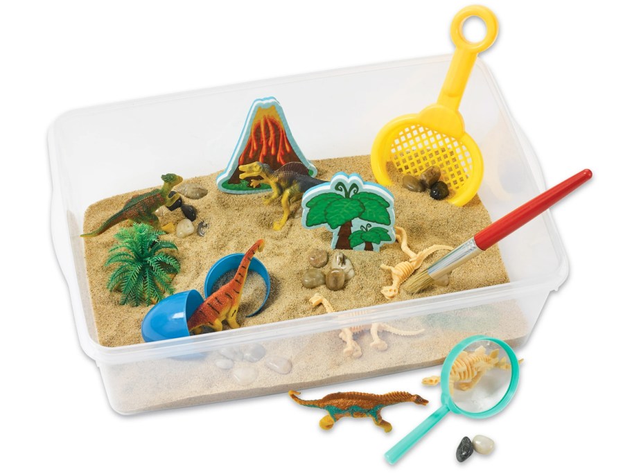 dinosaur themed sensory bin filled with sand