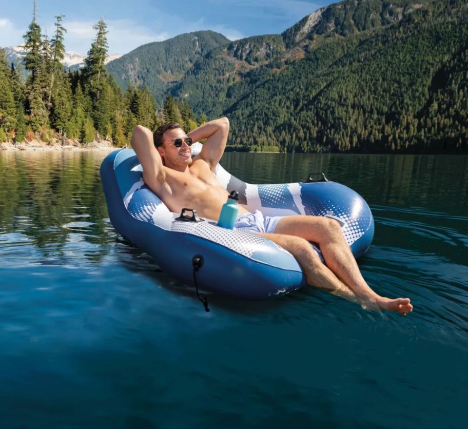 a man in a swimsuit on a tube style pool float