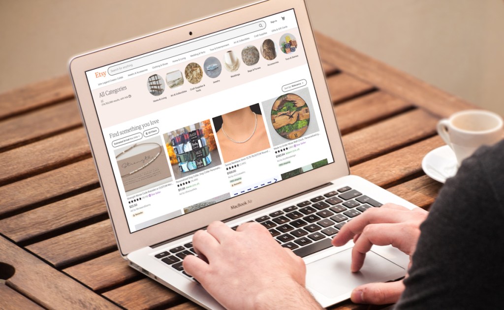 hands typing on computer with etsy on screen