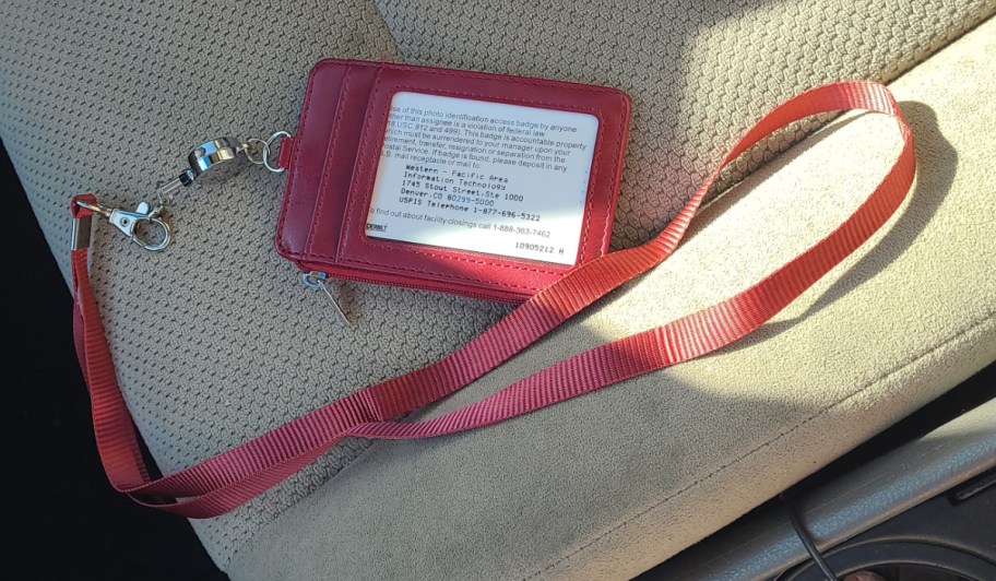 maroon lanyard id holder on car seat