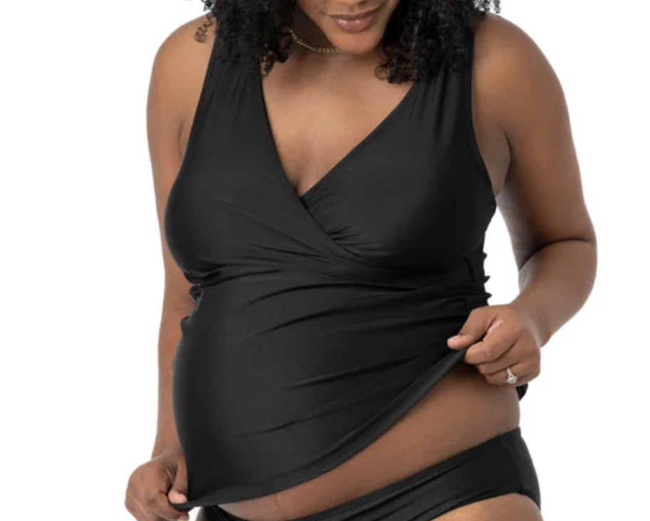 woman holding side of maternity tankini