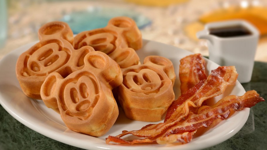 mickey mouse waffles on a plate with bacon