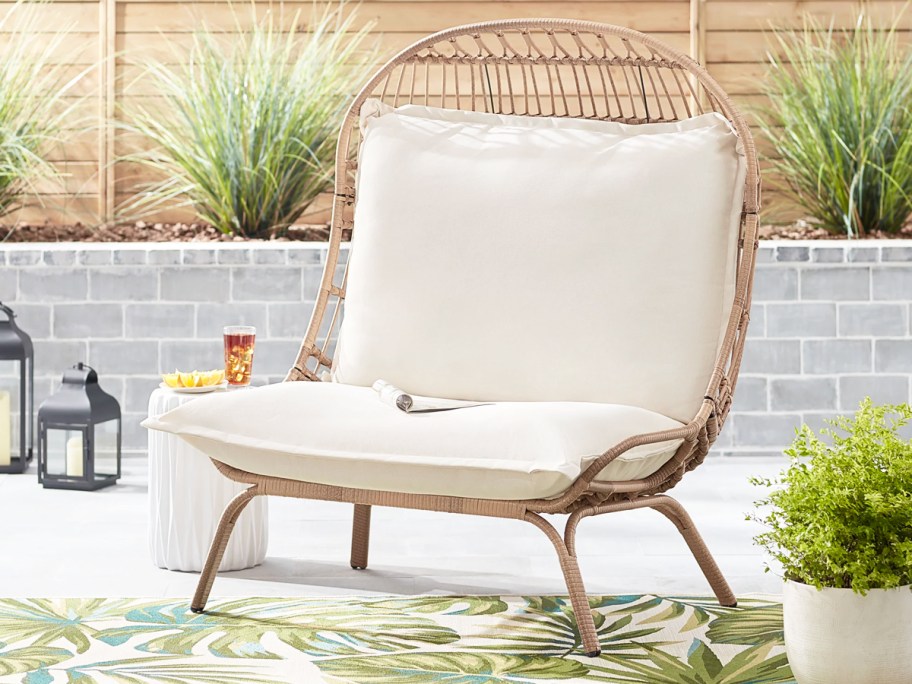wicker patio chair with white cushions