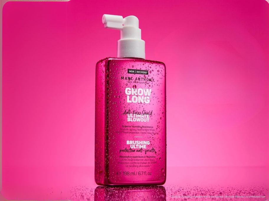 Marc Anthony Anti-Frizz Shield Ultimate Blowout Spray bottle against pink background