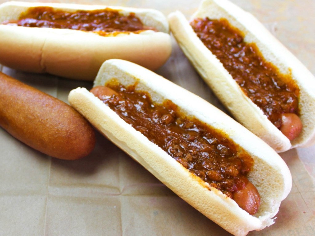 chili dogs next to a corn dog