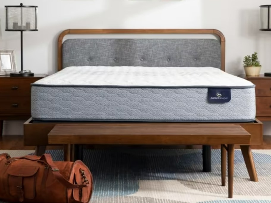 a mattress on a wood platform bed in a bedroom